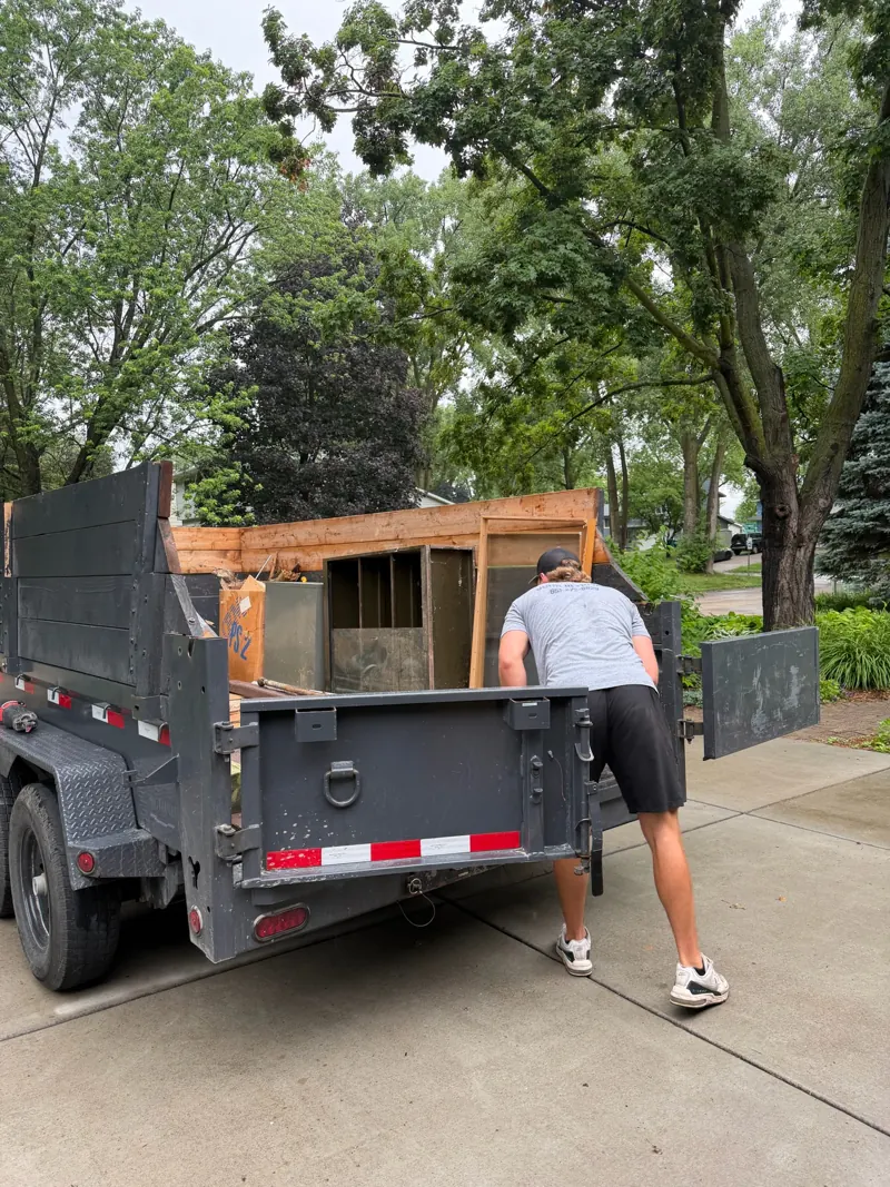 Crew loading old furniture into the trailer