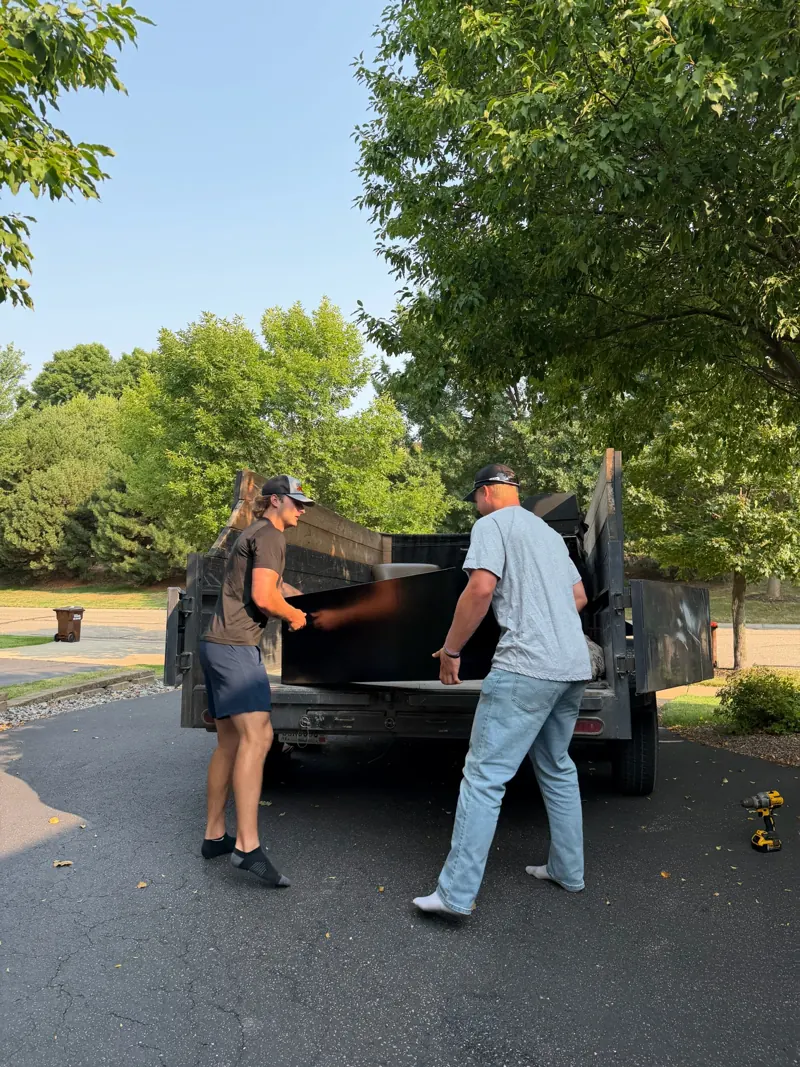 Two of the crew loading a trailer