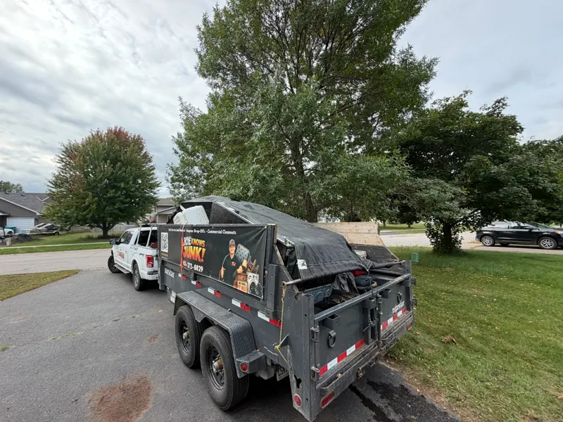 A tarped, full trailer on a driveway